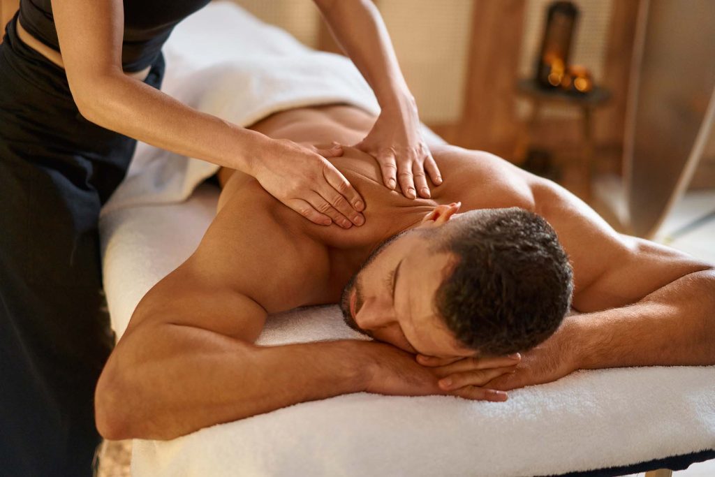 Man getting back massage by masseuse, Thai Massage Byron Bay